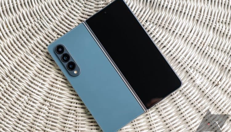 The Galaxy Z Fold 4 lying flat with its hinge open and inner display facing down.