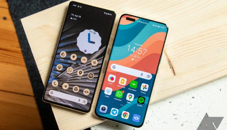 The Honor Magic 5 Pro sitting on a table next to a Google Pixel 7 Pro smartphone