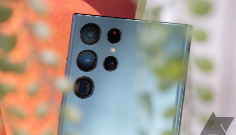 The back of a blue Samsung Galaxy S22 Ultra with its camera stack in focus. 