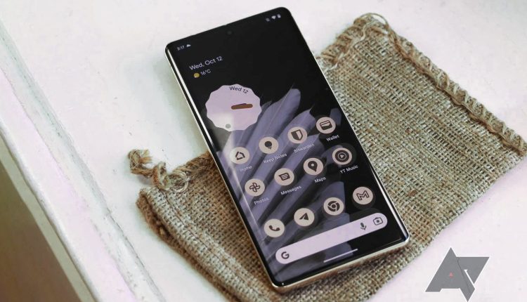 A Pixel 7 Pro sits atop a burlap bag and distressed white surface. 