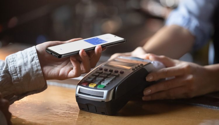 Swiping an Edge phone over a payment device.