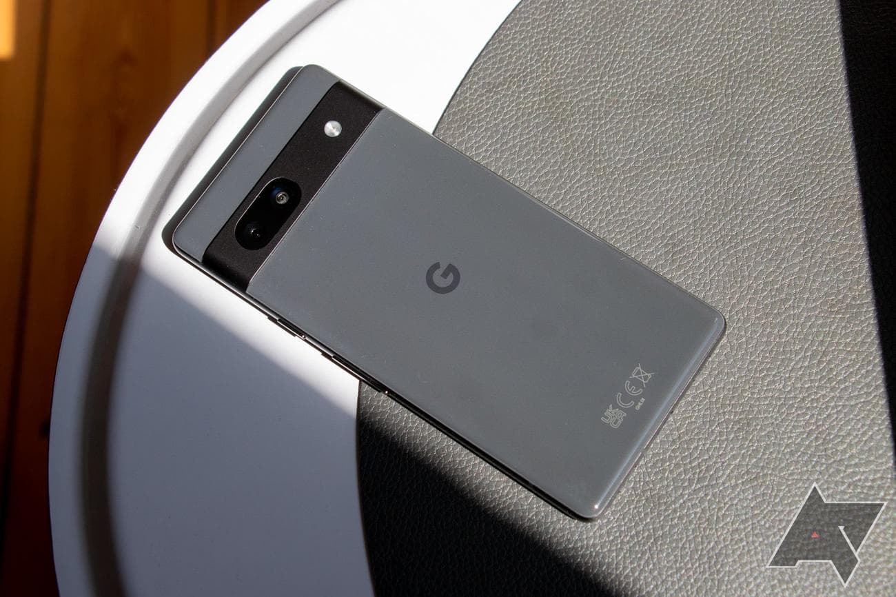 Ένα γκρι Pixel 7a ξαπλωμένο σε ένα τραπέζι στον ήλιο