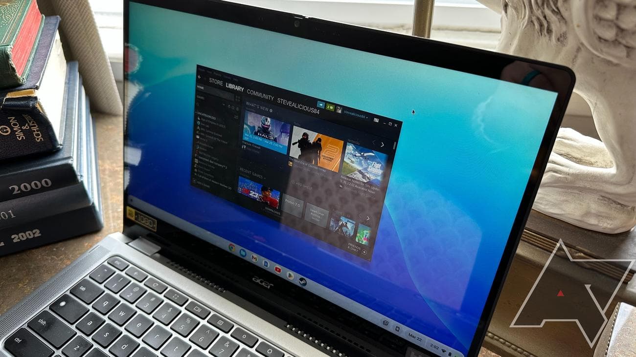 An Acer Chromebook Spin 514 with Steam open on a desk with books and a statue in the background