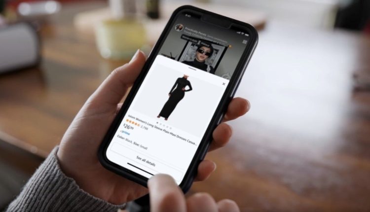 A close image of a person's hands shopping for a dress using the Amazon mobile app.