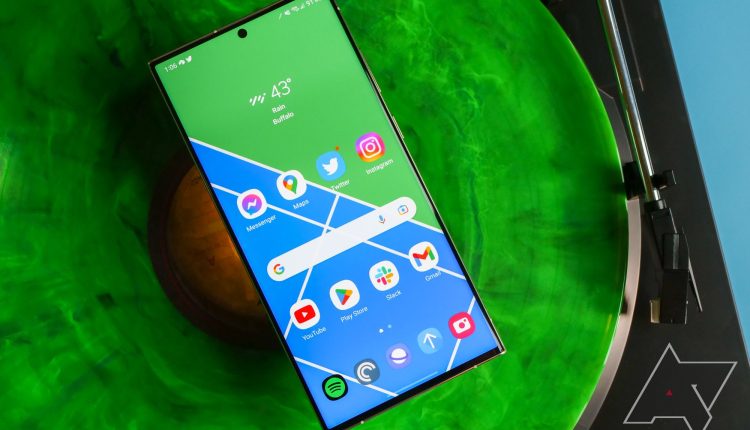 A smartphone sitting on a vinyl record. 