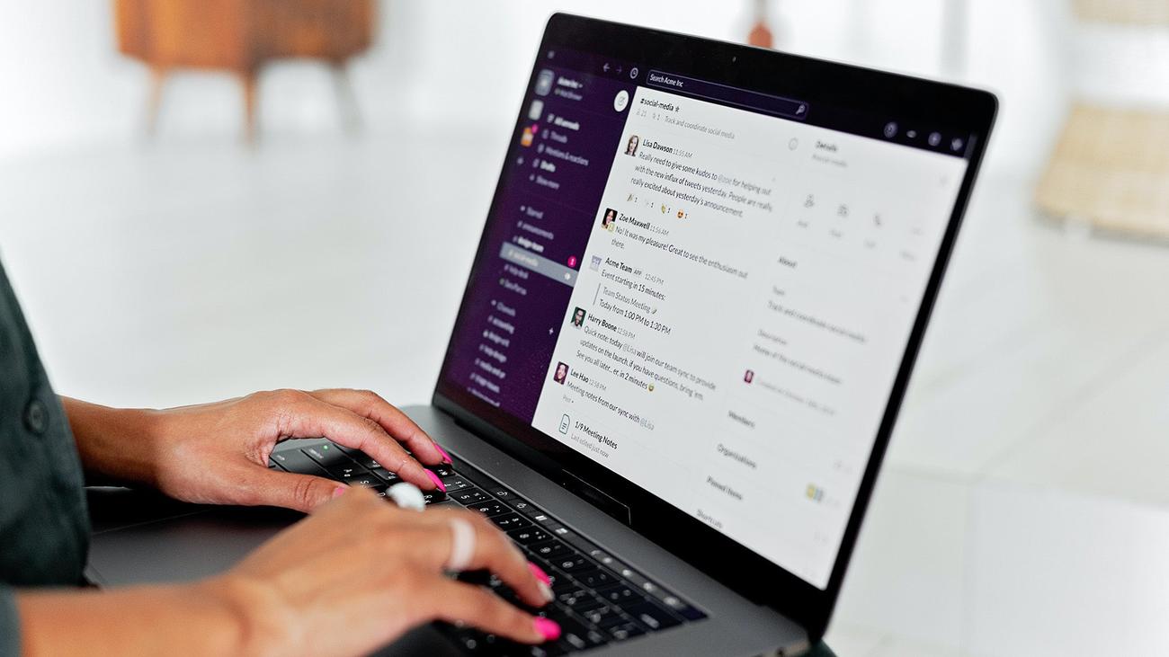 Person using Slack on their laptop
