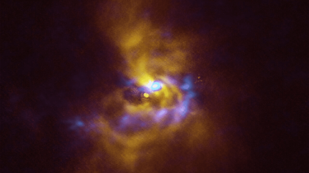 A young star named V960 Mon is at the center, with dusty material with the potential to form planets surrounding it. V960 Mon is located over 5000 light-years away from Earth in the constellation Monoceros.