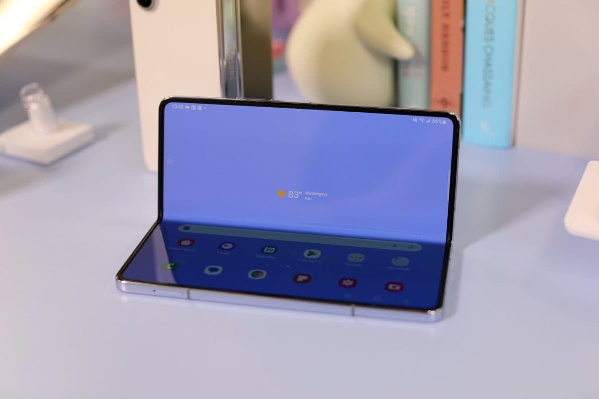samsung galaxy z fold sitting on a desk half folded up