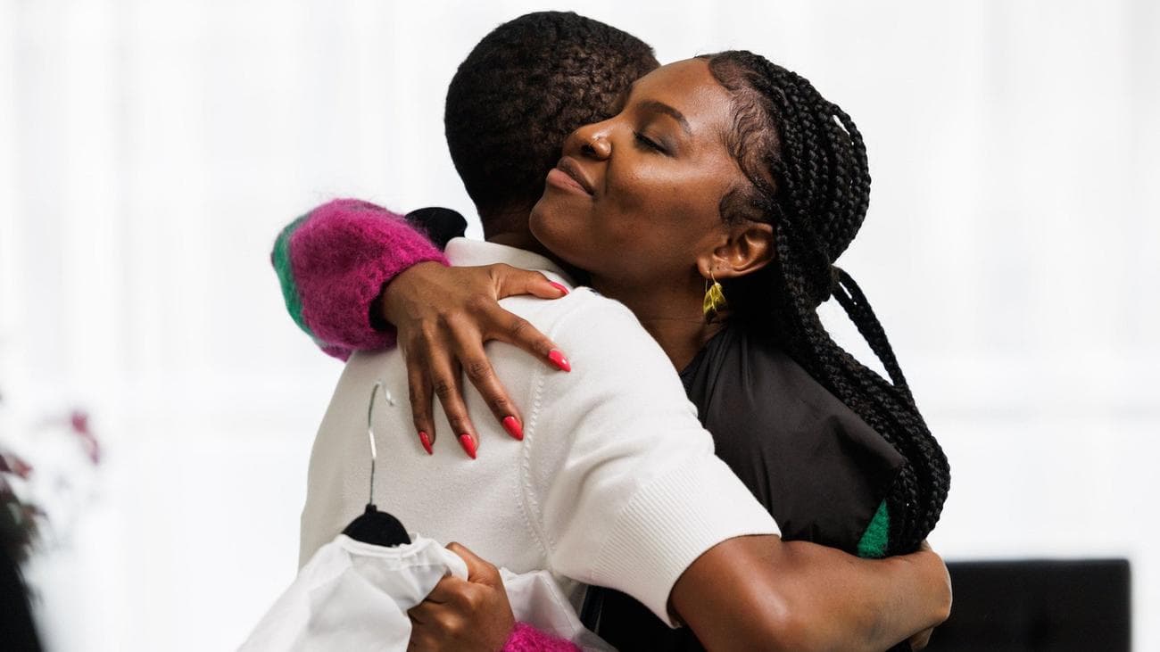 Genesis Lynea and Déja J. Bowens hug in the TV show "Champion"