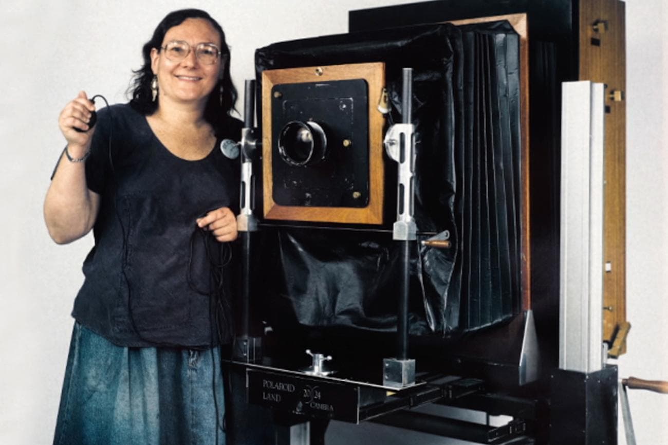 Errol Morris stands beside a camera