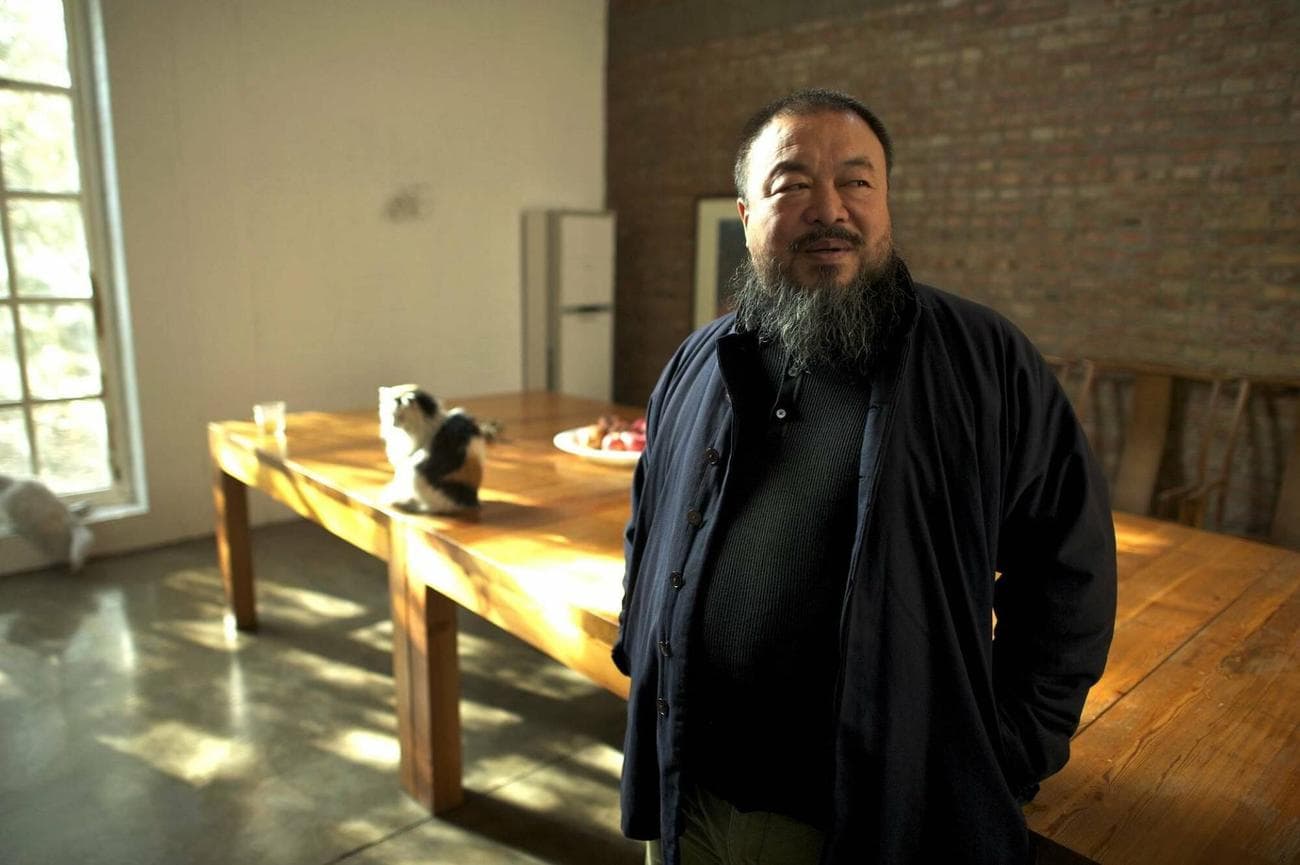 Ai Weiwei stands in his studio with his cats.