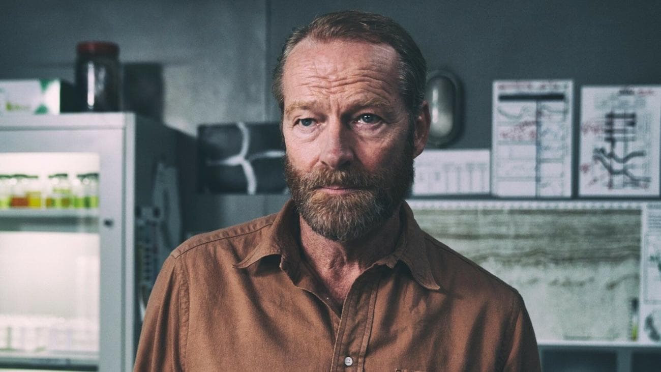 Iain Glen stands in an oil rig office in the show "The Rig"