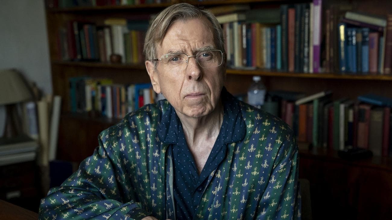 Timothy Spall sits in a library in "The Sixth Commandment"