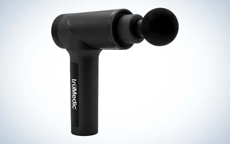 A black Trumedic massage gun with a massage ball on the end.