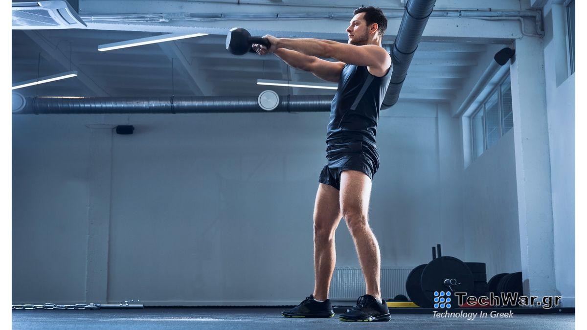 Person performing a kettlebell swing with arms extended in front