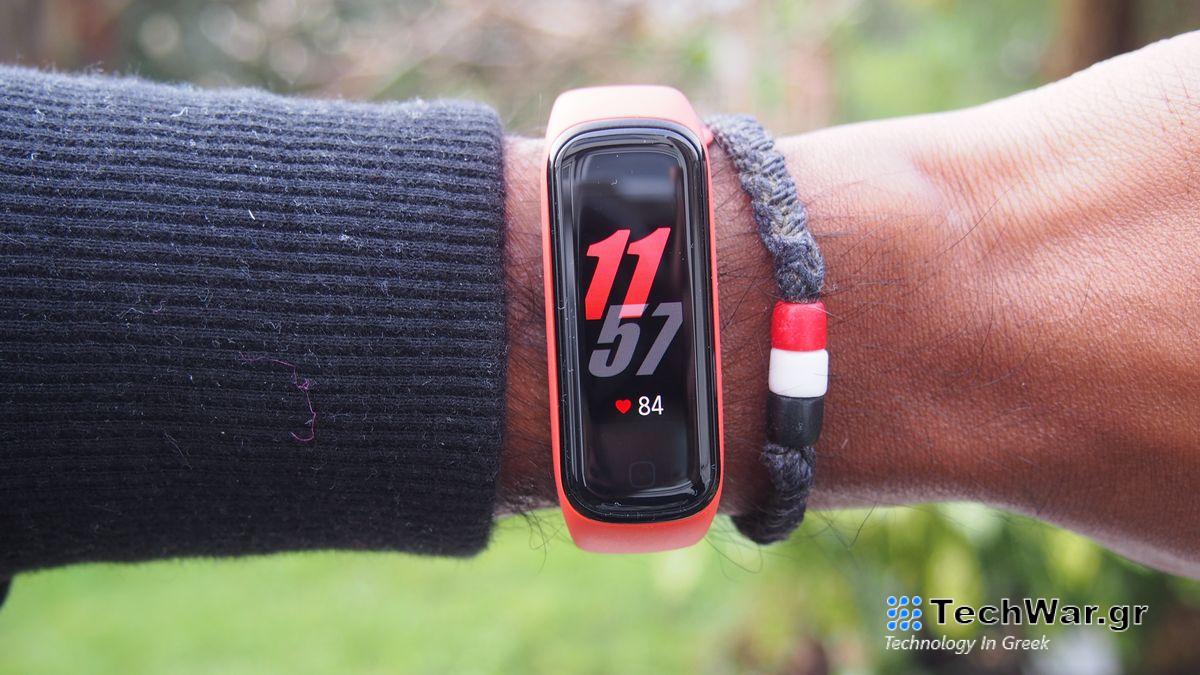 A Samsung Galaxy Fit 2 displaying the time, worn on someone