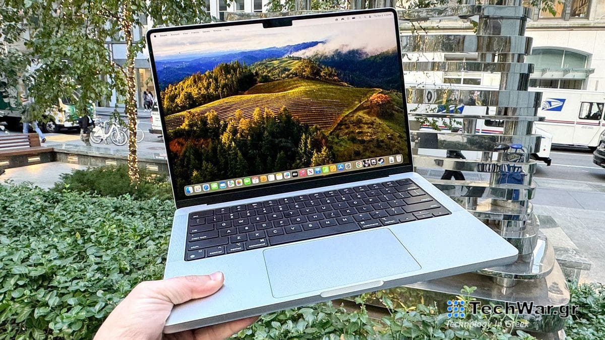 MacBook Pro 14-inch M3 holding in air open 