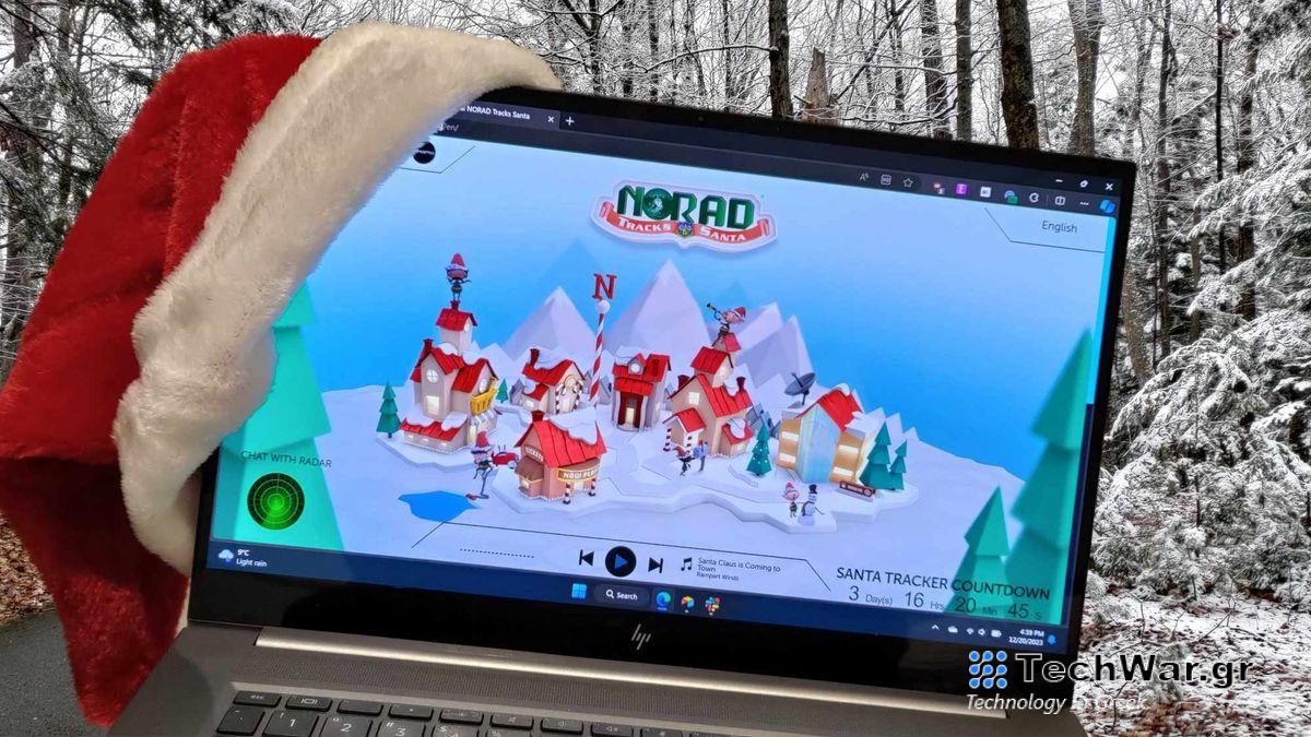 HP laptop wearing a Santa hat set on a snowscape