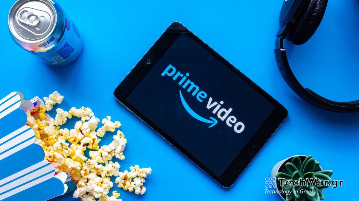 Prime Video logo appears on a tablet surrounded by a can of soda, spilled popcorn, headphones and a cactus