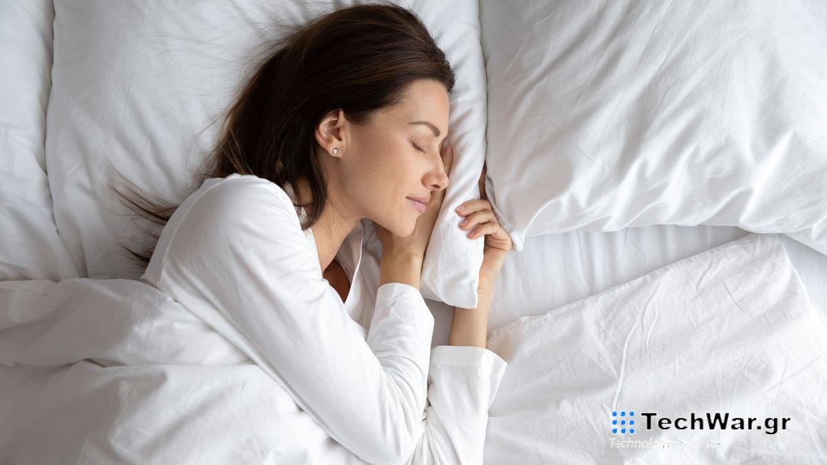 A woman with dark hair sleeps happily on a cooling mattress