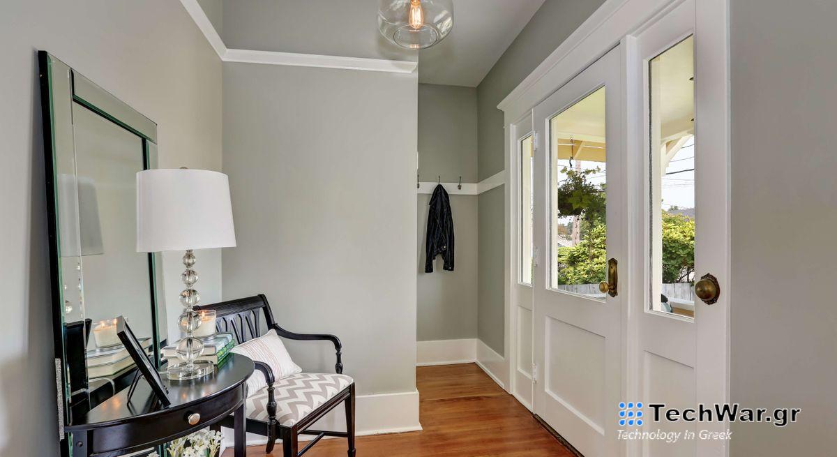 Light and bright entryway with a console table, pendant light , mirror and chair