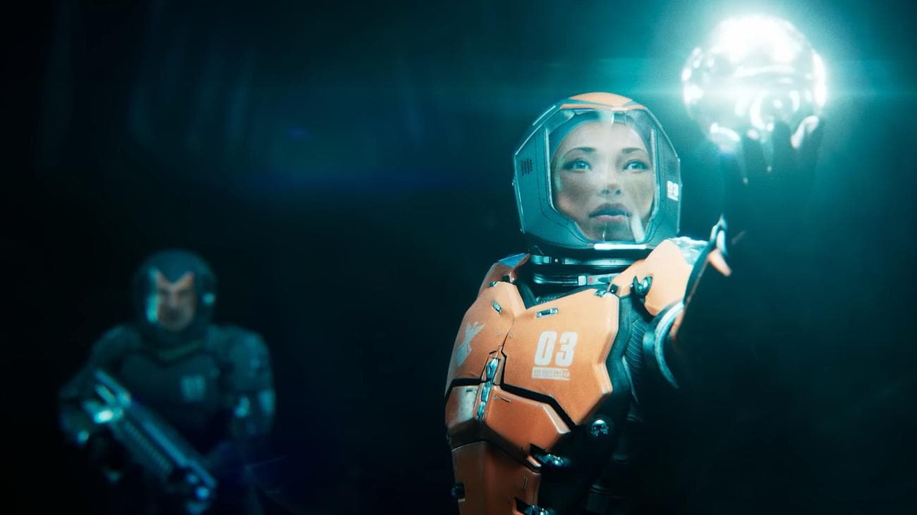 Ημερομηνία κυκλοφορίας του Exodus: Ο Max απλώνει το χέρι για να αγγίξει ένα από τα Ουράνια τεχνουργήματα που θα μπορούσαν να σώσουν τη Γη καθώς ο Tom στέκεται φρουρός πίσω της, με το τουφέκι στο χέρι.