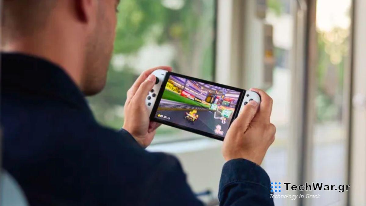 Portable Nintendo Switch OLED played by man on train