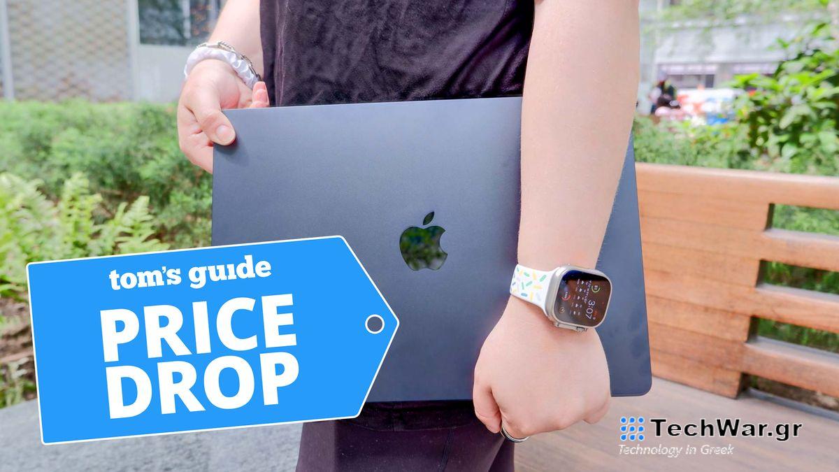 Man holding a 15-inch MacBook Air with lid closed