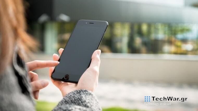 A woman holding a smartphone