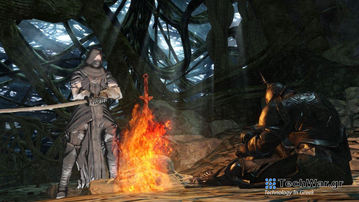 A screenshot from Dark Souls 2 of two figures by a bonfire.