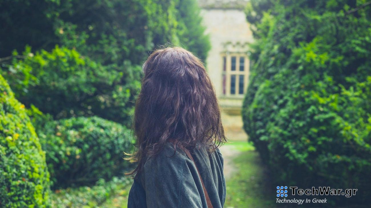 The back of a woman's head in a garden setting