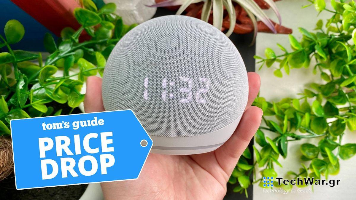 Echo Dot with Clock (5th Generation) in hand with house plants in background