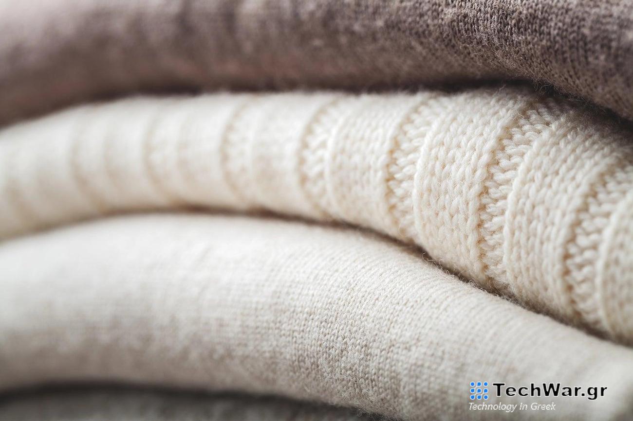 a pile of white and brown sweaters