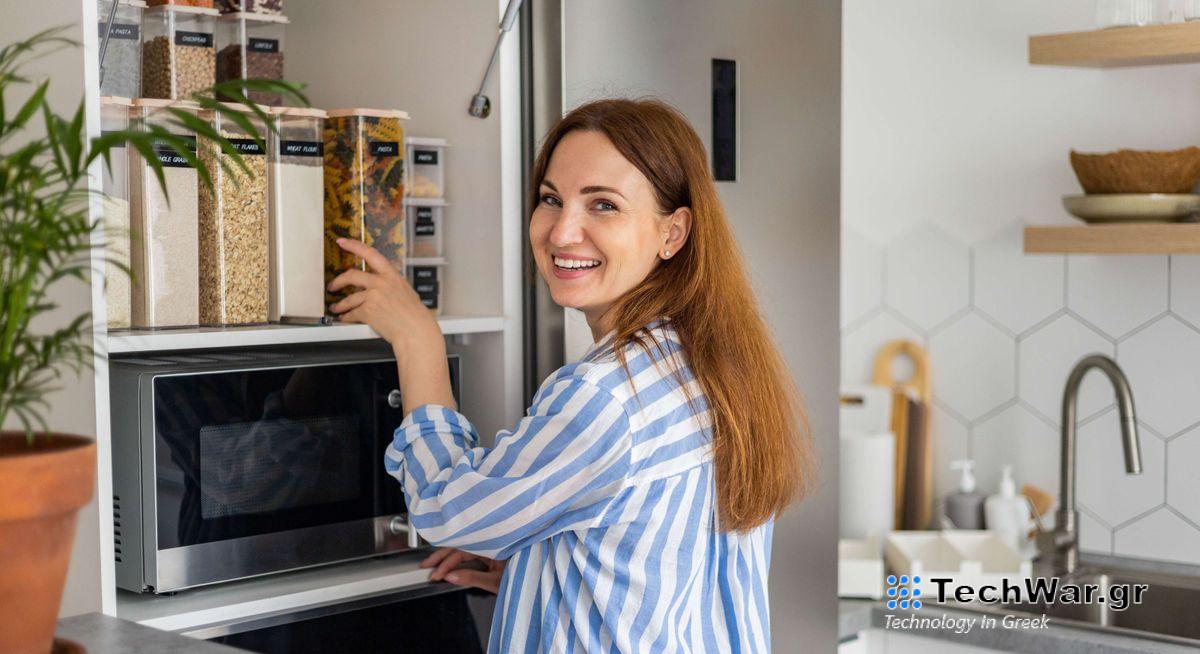 Woman smiling and organizing a tidy kitchen