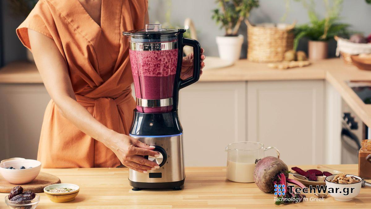 A blender filled with beetroots being run in a kitchen