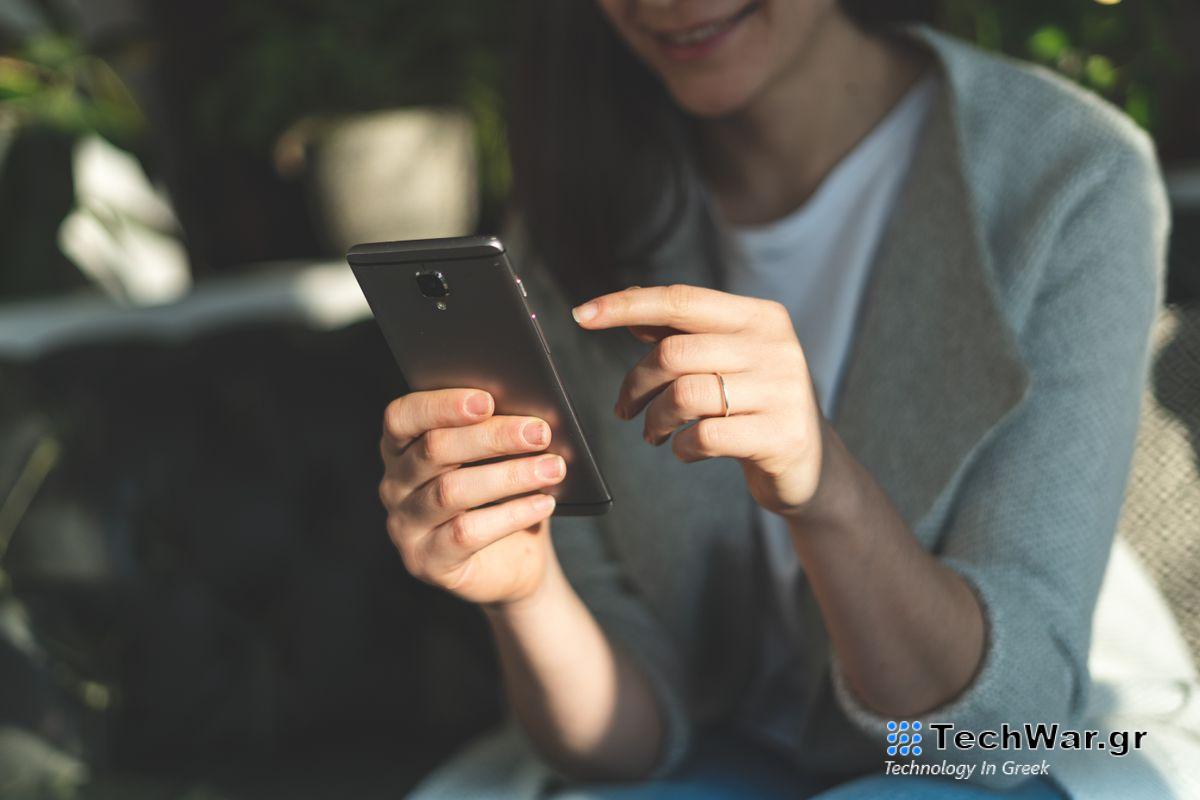 A woman using an Android phone.