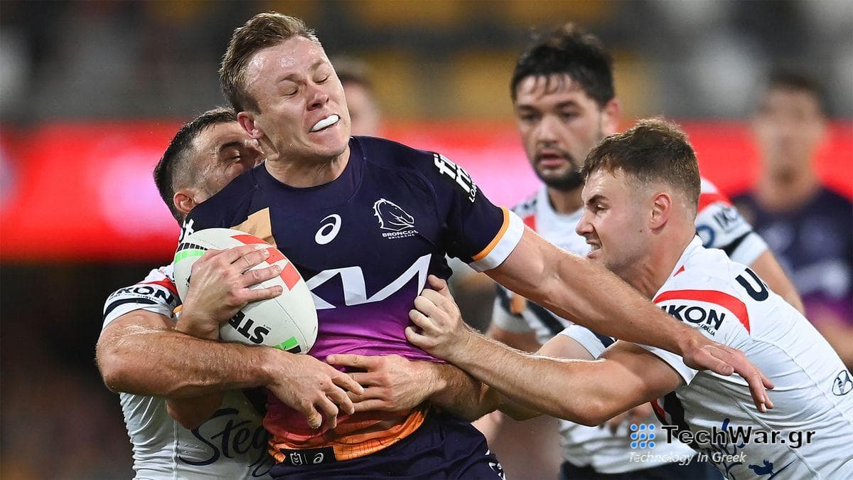 Billy Walters of the Broncos is tackled by Roosters players in a 2023 match.