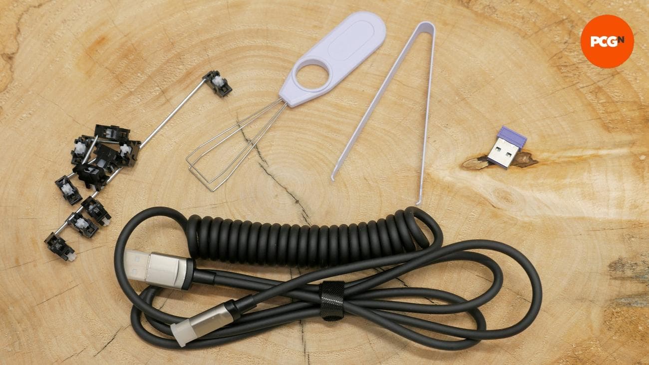 Monsgeek M1W SP review image showing the dongle stabs removal tool.